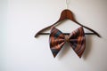 bow tie hanging on a suit hanger