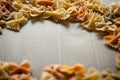 Bow tie pasta frame on gray background Royalty Free Stock Photo