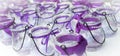 Bow-tied purple ribbons on glass candle holders.