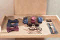 bow ties, neckties, glasses and wristwatch laying on wooden display Royalty Free Stock Photo