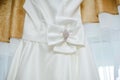 Bow on a white dress of the bride. Accessories and details