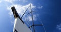 Bow of a white sailing yacht against the blue sky, generous copy space, selected focus. Royalty Free Stock Photo