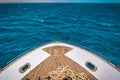 Bow of white yacht. Bay with thick rope lies on wooden deck Royalty Free Stock Photo