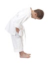 Bowing boy in judo kimono,