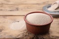 Bowl of active dry yeast on wooden table, closeup. Space for text Royalty Free Stock Photo