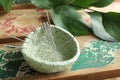 Bowl with acupuncture needles on wooden table, closeup. Space for text Royalty Free Stock Photo