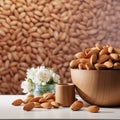 A bowl of almonds and flowers standing on a table on the background of almond wallpaper