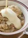 Bowl of Apple Crumble with Custard Royalty Free Stock Photo