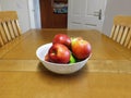 Bowl of Apples on kitchen table Royalty Free Stock Photo