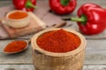 Bowl with aromatic paprika powder on wooden table, closeup Royalty Free Stock Photo