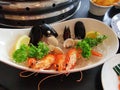 A bowl of assorted seafood fresh prawns clam mussels with lemon