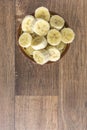 Bowl with banana slices on wooden background