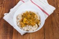 Bowl of barley porridge with meat sauce on rustic table Royalty Free Stock Photo