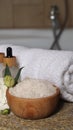 Bowl with bath salt and cosmetic product near fluffy towel on wicker mat indoors Royalty Free Stock Photo