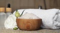 Bowl with bath salt and cosmetic product near fluffy towel on wicker mat indoors Royalty Free Stock Photo