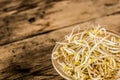 Bowl of bean sprouts on a rustic wooden table