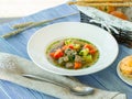 Bowl of beef soup and vegetables on the table in blue Royalty Free Stock Photo