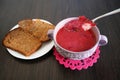 bowl of beet root soup borsch on dark wooden table with bread in plate, traditional Ukrainian or Russian soup borscht