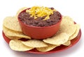 Bowl of Black Bean Dip with Chips on a White Background