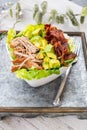 Bowl of BLT salad with lettuce, meat, bacon and avocados Royalty Free Stock Photo