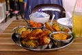 A bowl of Blue Butterfly Pea Flower coconut rice served with a few popular local dishes like chicken curry and sweet and sour fish Royalty Free Stock Photo