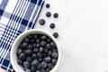 Bowl of blueberries fruit on white marble background Royalty Free Stock Photo