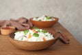 Bowl of boiled rice with vegetables on table. Royalty Free Stock Photo