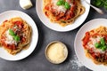 A bowl of Bolognese sauce, served on a bed of perfectly cooked pasta and garnished with a sprinkle of freshly grated Parmesan