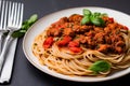 A bowl of Bolognese sauce, served on a bed of perfectly cooked pasta and garnished with a sprinkle of freshly grated Parmesan