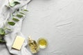 Bowl, bottle of eucalyptus essential oil and soap on light background