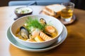 bowl of bouillabaisse with seafood and rouille on toast