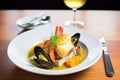 bowl of bouillabaisse with seafood and rouille on toast