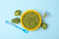 Bowl with broccoli puree on background, top view Royalty Free Stock Photo