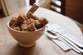 Bowl with brown sugar and silverwear Royalty Free Stock Photo