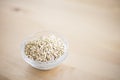 Bowl of buckwheat groats on wooden table