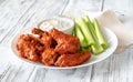 Bowl of buffalo wings with blue cheese dip