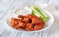 Bowl of buffalo wings with blue cheese dip