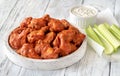 Bowl of buffalo wings with blue cheese dip