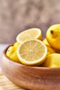 Bowl of bunch of lemons and halves on a marble surface Royalty Free Stock Photo