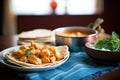 a bowl of butter chicken beside a stack of fresh chapatis Royalty Free Stock Photo