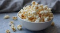 Bowl of buttery popcorn on gray surface Royalty Free Stock Photo