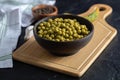 Bowl canned olives on wooden board