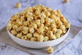 Bowl of caramel popcorn with blurred background