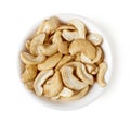 Bowl of cashew nuts isolated on white, top view