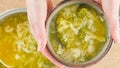 Bowl of cauliflower broccoli soup close-up in woman hands Royalty Free Stock Photo