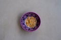 Bowl of ceral in purple turkish bowl, on a white marble tabletop