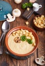 Bowl of champignon mushroom cream soup puree with croutons and basil leaf Royalty Free Stock Photo