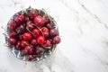 Bowl with cherries on marble background Top view with copy space Royalty Free Stock Photo