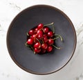 Bowl of cherries on marble table, from above Royalty Free Stock Photo