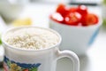 bowl of cherry tomatoes and a cup of rice Royalty Free Stock Photo